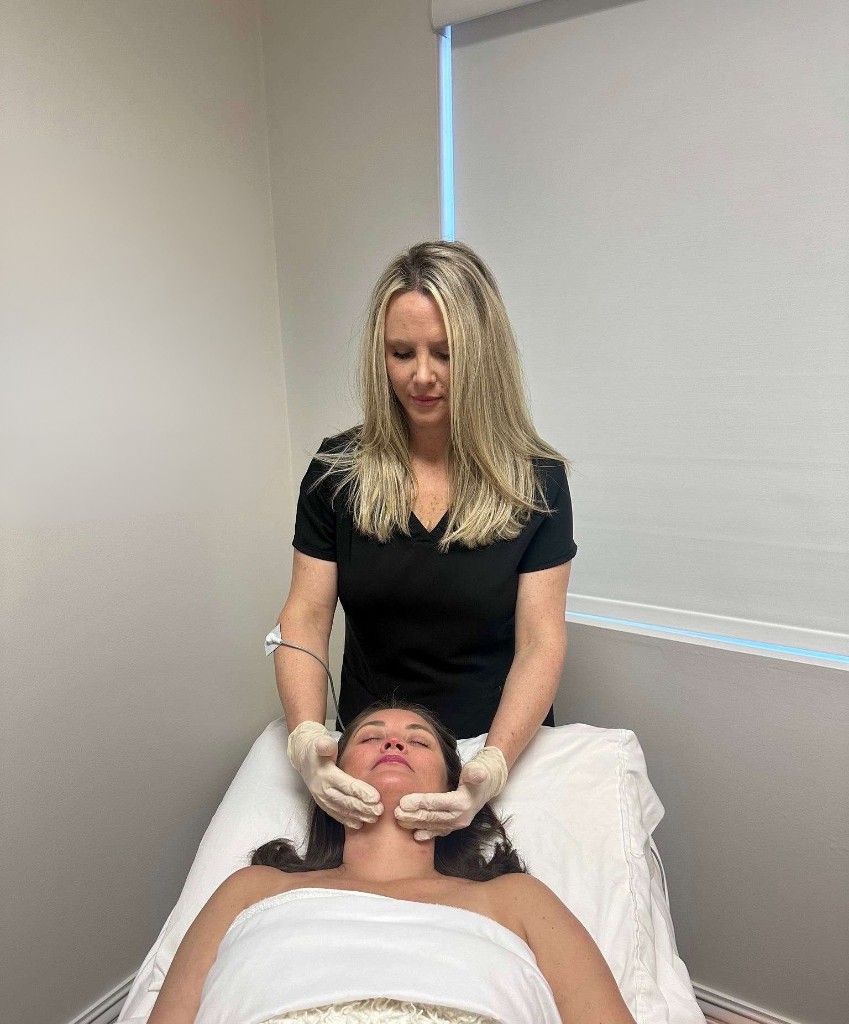 Mandy performing a lymphatic facial treatment with Deep Oscillation Therapy